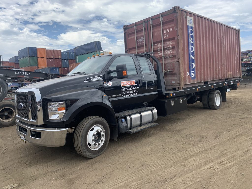 UBOXIT flatbed truck loaded with a 20ft shipping container